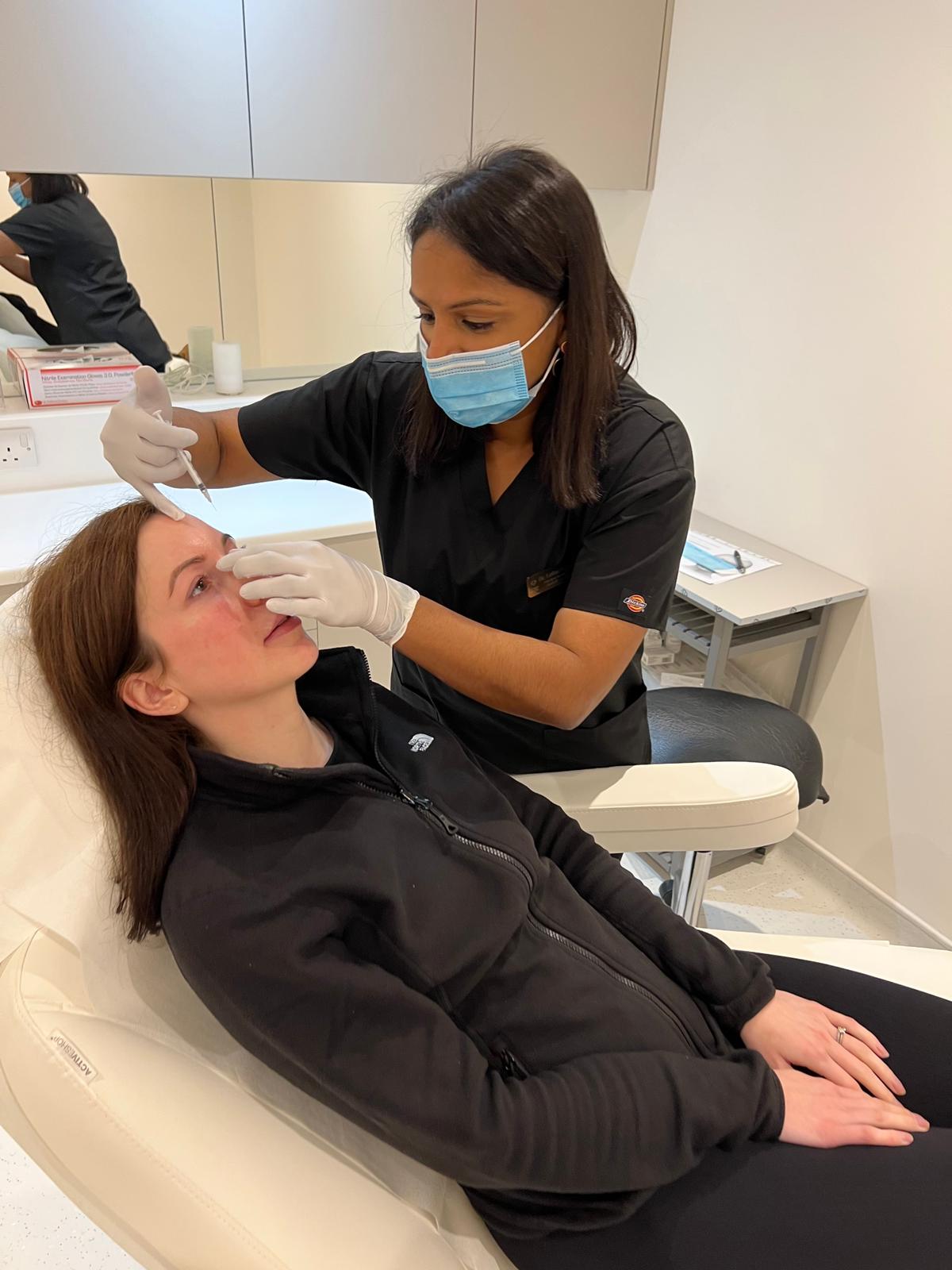 patient receiving botox treatment from the dentist