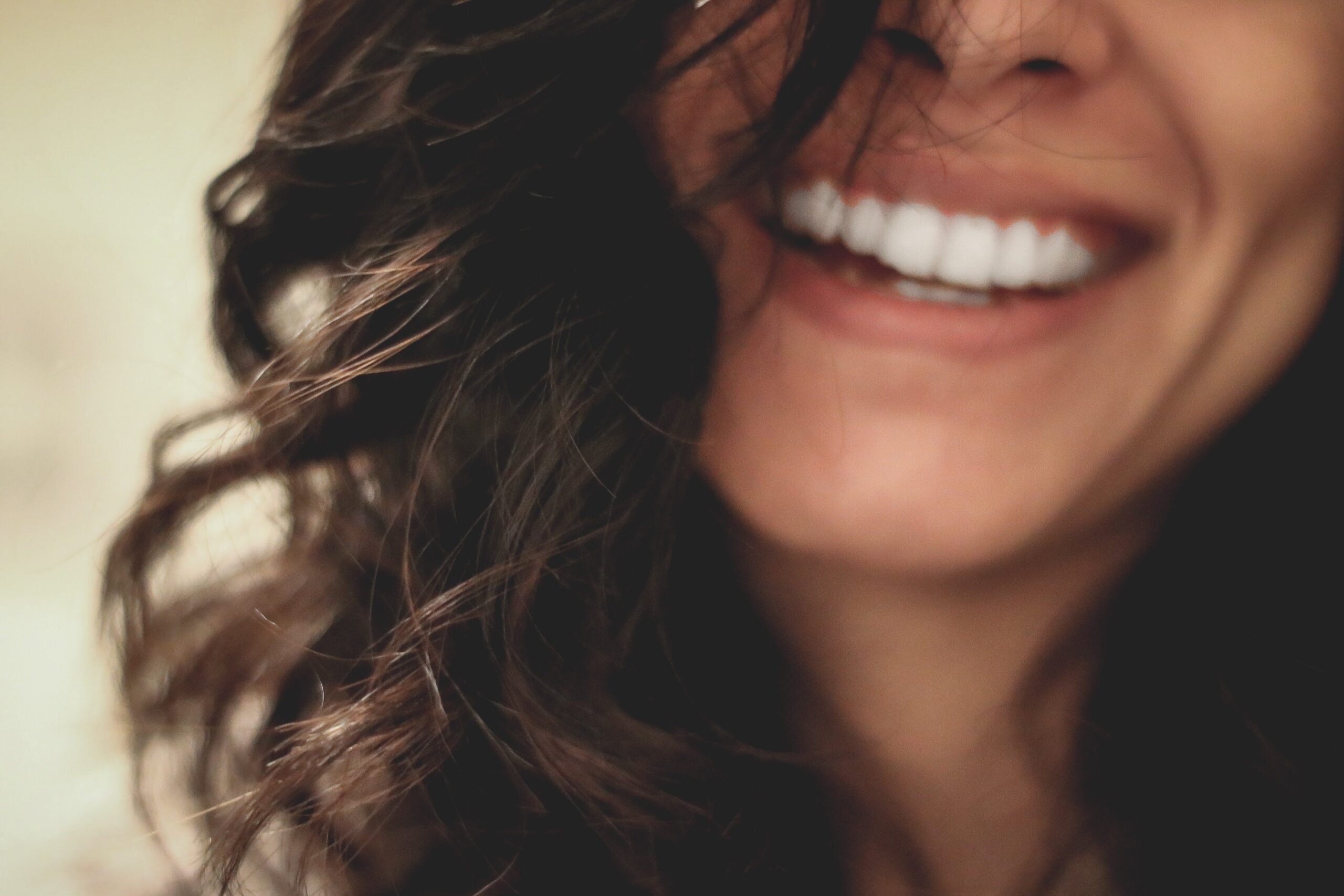 long black haired woman smiling close-up photography. Should I floss?