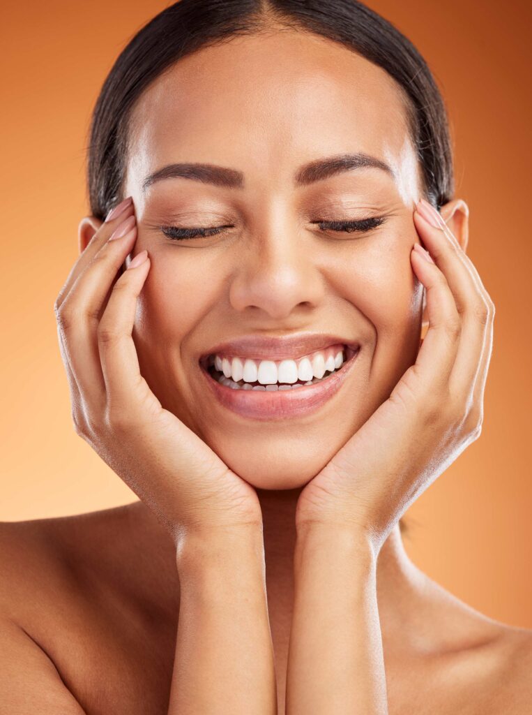 Woman with perfect smile smiling at the camera, dentist london, renu dental & medispa. showing her white teeth.